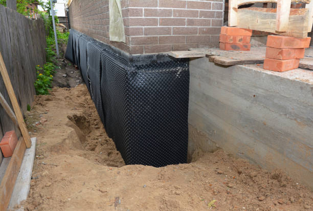 Happy homeowners after waterproofing job in Marquette
